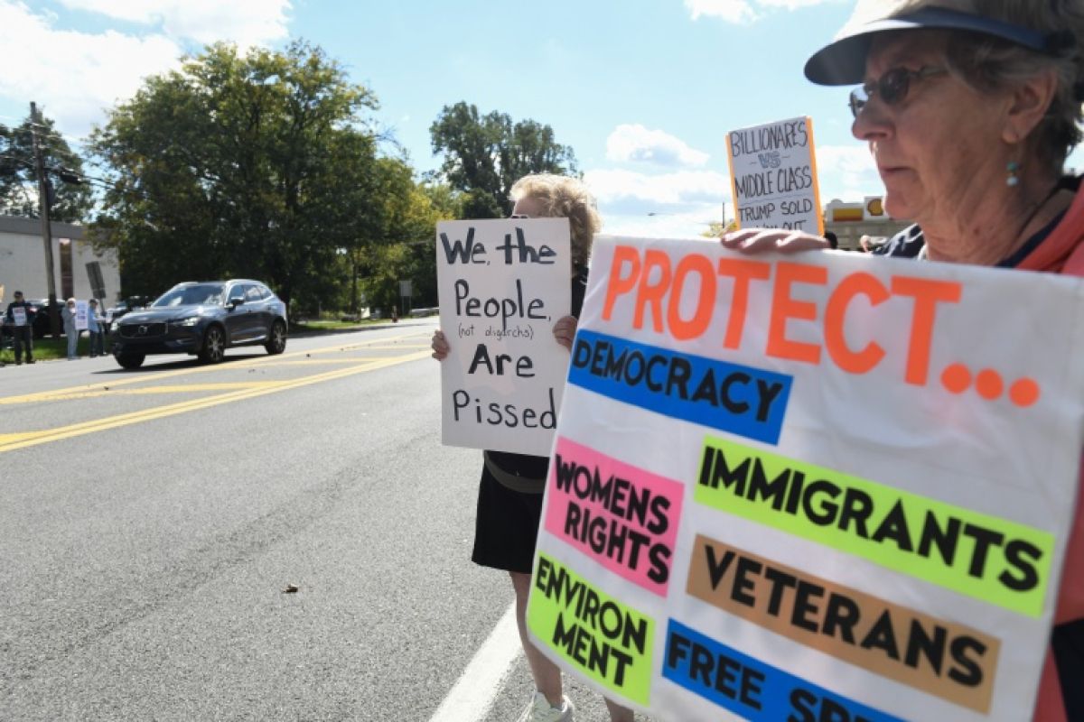 Chaque lundi, ils brandissent leurs pancartes contre Trump au bord du boulevard